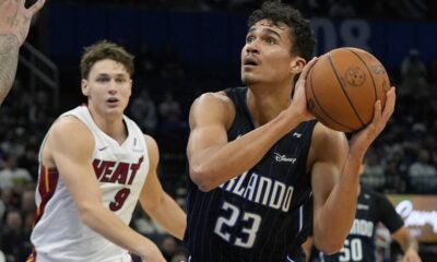 Orlando Magic forward Tristan da Silva (23) looks for a shot as Miami Heat guard Pelle Larsson (9) tries to defend during the second half of an NBA basketball game, Saturday, Dec. 21, 2024, in Orlando, Fla. (AP Photo/John Raoux)