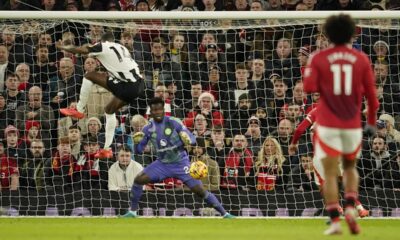 Newcastle's Alexander Isak, left, scores his side's opening goal during the English Premier League soccer match between Manchester United and Newcastle at the Old Trafford stadium in Manchester, England, Monday, Dec. 30, 2024. (AP Photo/Dave Thompson)