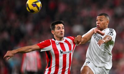 Athletic Bilbao's Daniel Vivian, left, challenges Real Madrid's Kylian Mbappe during the Spanish La Liga soccer match between Athletic Bilbao and Real Madrid at the San Mames stadium in Bilbao, Spain, Wednesday, Dec. 4, 2024. (AP Photo/Miguel Oses)