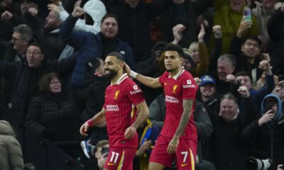 Liverpool's Mohamed Salah, left, celebrates with teammate Luis Diaz after scoring his side's fifth goal during the English Premier League soccer match between Tottenham and Liverpool at Tottenham Hotspur Stadium in London, Sunday, Dec. 22, 2024. (AP Photo/Dave Shopland)