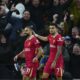 Liverpool's Mohamed Salah, left, celebrates with teammate Luis Diaz after scoring his side's fifth goal during the English Premier League soccer match between Tottenham and Liverpool at Tottenham Hotspur Stadium in London, Sunday, Dec. 22, 2024. (AP Photo/Dave Shopland)