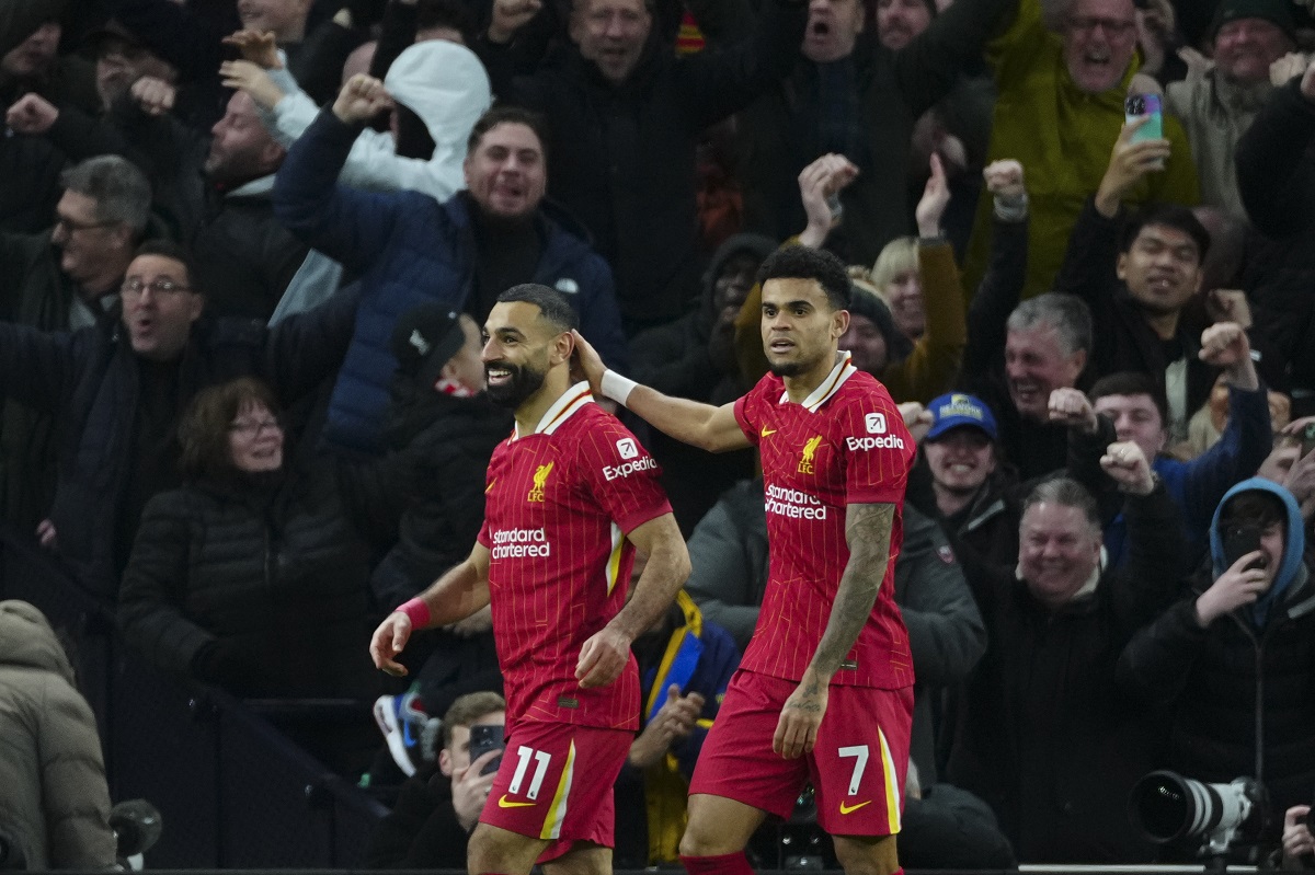 Liverpool's Mohamed Salah, left, celebrates with teammate Luis Diaz after scoring his side's fifth goal during the English Premier League soccer match between Tottenham and Liverpool at Tottenham Hotspur Stadium in London, Sunday, Dec. 22, 2024. (AP Photo/Dave Shopland)