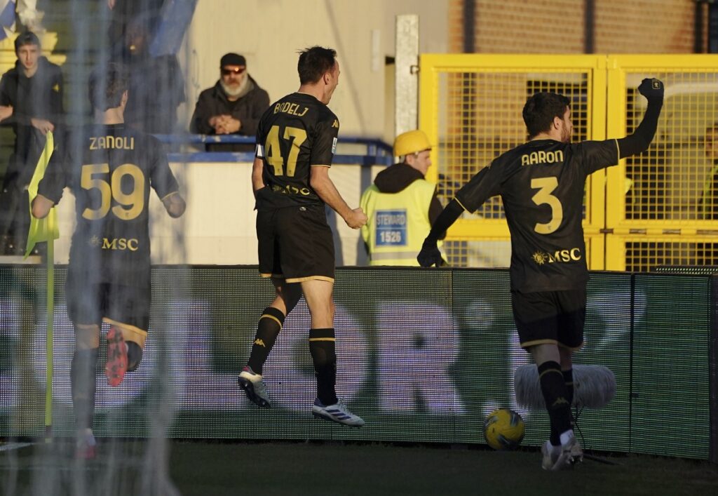 Genoa's Milan Badelj, centre, celebrates after scoring the opening goal during the Serie A soccer match between Empoli and Genoa at the Carlo Castellani stadium in Empoli, Italy, Saturday, Dec. 28, 2024. (Marco Bucco/LaPresse via AP)