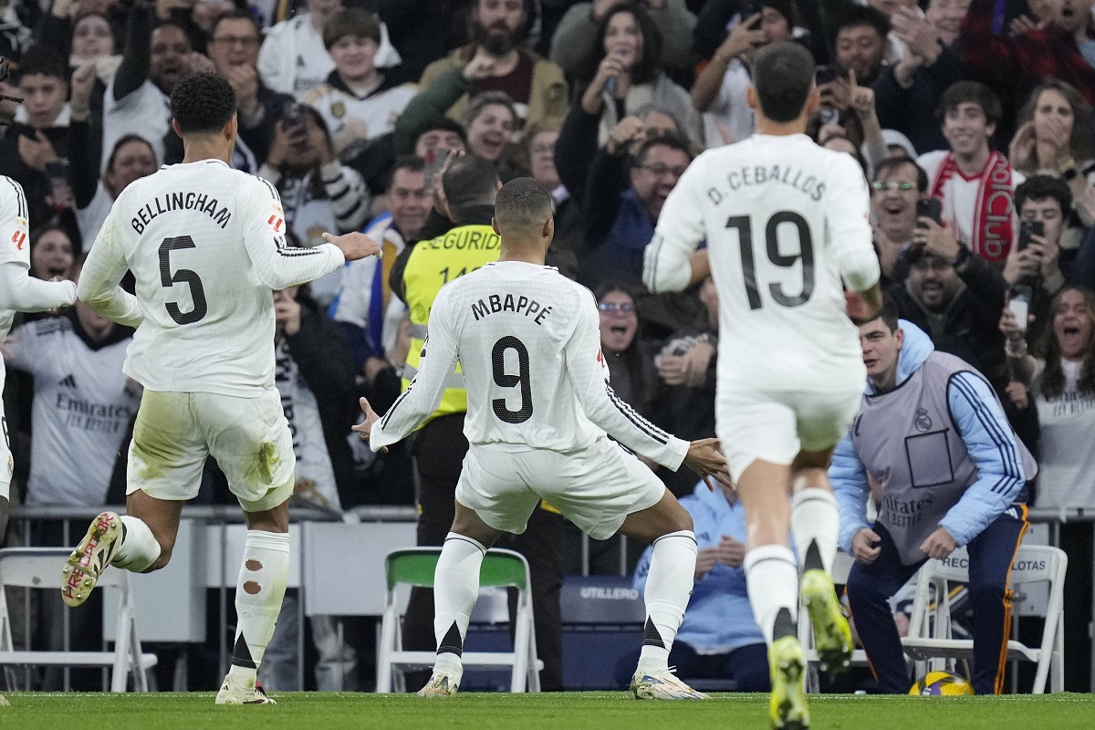 Real Madrid's Kylian Mbappe celebrates after scoring the opening goal during the Spanish La Liga soccer match between Real Madrid and Sevilla at the Santiago Bernabeu Stadium in Madrid, Spain, Sunday, Dec. 22, 2024. (AP Photo/Bernat Armangue)