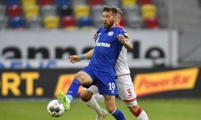 FILE - Schalke's Guido Burgstaller, left, is challenged by Duesseldorf's Andre Hoffman during the German Bundesliga soccer match between Fortuna Duesseldorf and FC Schalke 04 in Duesseldorf, Germany, on May 27, 2020. (AP Photo/Martin Meissner, Pool, File)