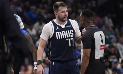 Dallas Mavericks guard Luka Doncic (77) questions a call by referee Sean Wright (4) during the first half of an NBA basketball game against the Portland Trail Blazers, Monday, Dec. 23, 2024, in Dallas. (AP Photo/LM Otero)