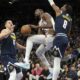 Phoenix Suns forward Kevin Durant drives between Denver Nuggets center Nikola Jokic (15) and forward Peyton Watson during the second half of an NBA basketball game, Wednesday, Dec. 25, 2024, in Phoenix. Phoenix won 110-100. (AP Photo/Rick Scuteri)