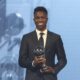 Vinicius Junior of Real Madrid is awarded as the Best Men's FIFA Player during the FIFA Football Awards 2024 in Doha, Qatar, Tuesday, Dec. 17, 2024. (AP Photo/Hussein Sayed)