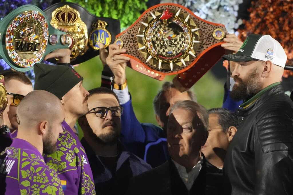 Boxers Britain's Tyson Fury, right, and world champion Ukraine's Oleksandr Usyk, center left, face off on stage during the weigh-in for their WBA, WBO, and WBC heavyweight title bout in Riyadh, Saudi Arabia, Friday, Dec. 20, 2024. (AP Photo/Frank Augstein)