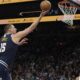 Denver Nuggets center Nikola Jokic scores on Phoenix Suns guard Tyus Jones during the first half of an NBA basketball game, Wednesday, Dec. 25, 2024, in Phoenix. (AP Photo/Rick Scuteri)