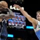 Dallas Mavericks guard Kyrie Irving (11) shoots against Atlanta Hawks guard Bogdan Bogdanovic (13) during the second half of an NBA basketball game, Monday, Nov. 25, 2024, in Atlanta. (AP Photo/Mike Stewart)