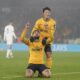 Wolverhampton Wanderers' Matheus Cunha, front, celebrates after Hwang Hee-Chan, top, scored their side's second goal during the English Premier League soccer match between Wolverhampton Wanderers and Manchester United at the Molineux Stadium, Wolverhampton, England, Thursday, Dec. 26, 2024. (David Davies/PA via AP)