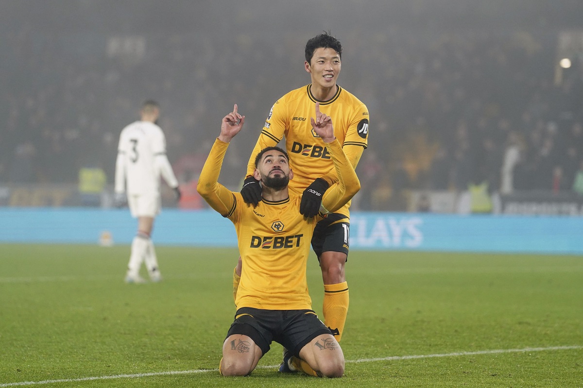 Wolverhampton Wanderers' Matheus Cunha, front, celebrates after Hwang Hee-Chan, top, scored their side's second goal during the English Premier League soccer match between Wolverhampton Wanderers and Manchester United at the Molineux Stadium, Wolverhampton, England, Thursday, Dec. 26, 2024. (David Davies/PA via AP)