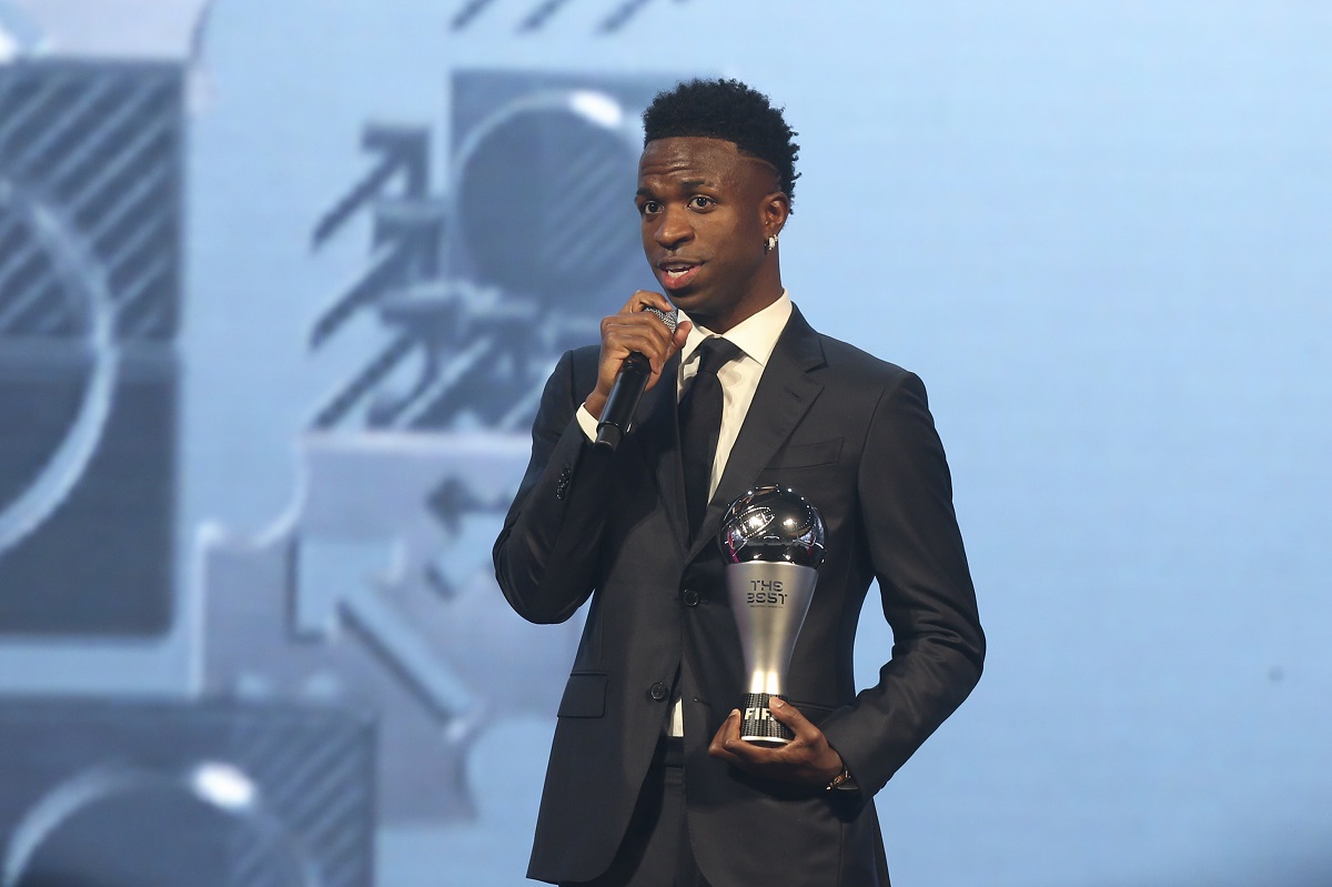 Vinicius Junior of Real Madrid talks after being awarded as the Best Men's FIFA Player during the FIFA Football Awards 2024 in Doha, Qatar, Tuesday, Dec. 17, 2024. (AP Photo/Hussein Sayed)