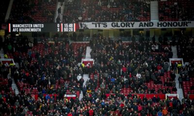 Spectators watch from the stands after the English Premier League soccer match between Manchester United and Bournemouth at the Old Trafford stadium in Manchester, England, Sunday, Dec. 22, 2024. (AP Photo/Dave Thompson)