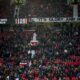 Spectators watch from the stands after the English Premier League soccer match between Manchester United and Bournemouth at the Old Trafford stadium in Manchester, England, Sunday, Dec. 22, 2024. (AP Photo/Dave Thompson)