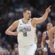 Denver Nuggets center Nikola Jokic gestures after hitting a basket in the second half of an NBA basketball game against the Phoenix Suns Monday, Dec. 23, 2024, in Denver. (AP Photo/David Zalubowski)