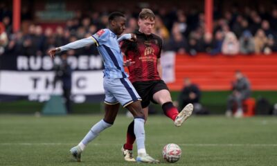 Tottenham Hotspur's Pape Matar Sarr, left, and Tamworth's Daniel Creaney battle for the ball during the English FA Cup third round match at The Lamb Ground, Tamworth, England, Sunday Jan. 12, 2025. (Joe Giddens/PA via AP)