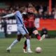 Tottenham Hotspur's Pape Matar Sarr, left, and Tamworth's Daniel Creaney battle for the ball during the English FA Cup third round match at The Lamb Ground, Tamworth, England, Sunday Jan. 12, 2025. (Joe Giddens/PA via AP)