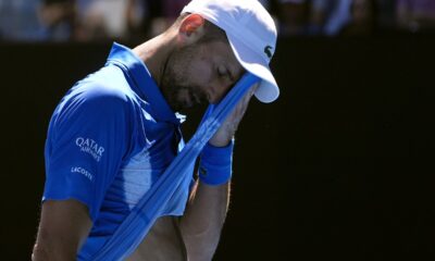 Novak Djokovic of Serbia wipes the sweat from his face during his semifinal match against Alexander Zverev of Germany at the Australian Open tennis championship in Melbourne, Australia, Friday, Jan. 24, 2025. (AP Photo/Asanka Brendon Ratnayake)