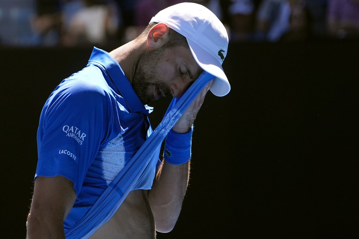 Novak Djokovic of Serbia wipes the sweat from his face during his semifinal match against Alexander Zverev of Germany at the Australian Open tennis championship in Melbourne, Australia, Friday, Jan. 24, 2025. (AP Photo/Asanka Brendon Ratnayake)