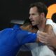 Novak Djokovic of Serbia celebrates with coach Andy Murry, right, after defeating Carlos Alcaraz of Spain in their quarterfinal match at the Australian Open tennis championship in Melbourne, Australia, early Wednesday, Jan. 22, 2025. (AP Photo/Asanka Brendon Ratnayake)