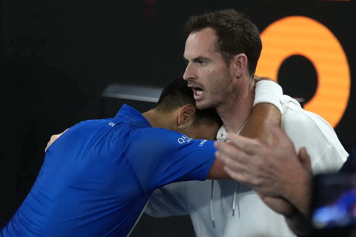 Novak Djokovic of Serbia celebrates with coach Andy Murry, right, after defeating Carlos Alcaraz of Spain in their quarterfinal match at the Australian Open tennis championship in Melbourne, Australia, early Wednesday, Jan. 22, 2025. (AP Photo/Asanka Brendon Ratnayake)