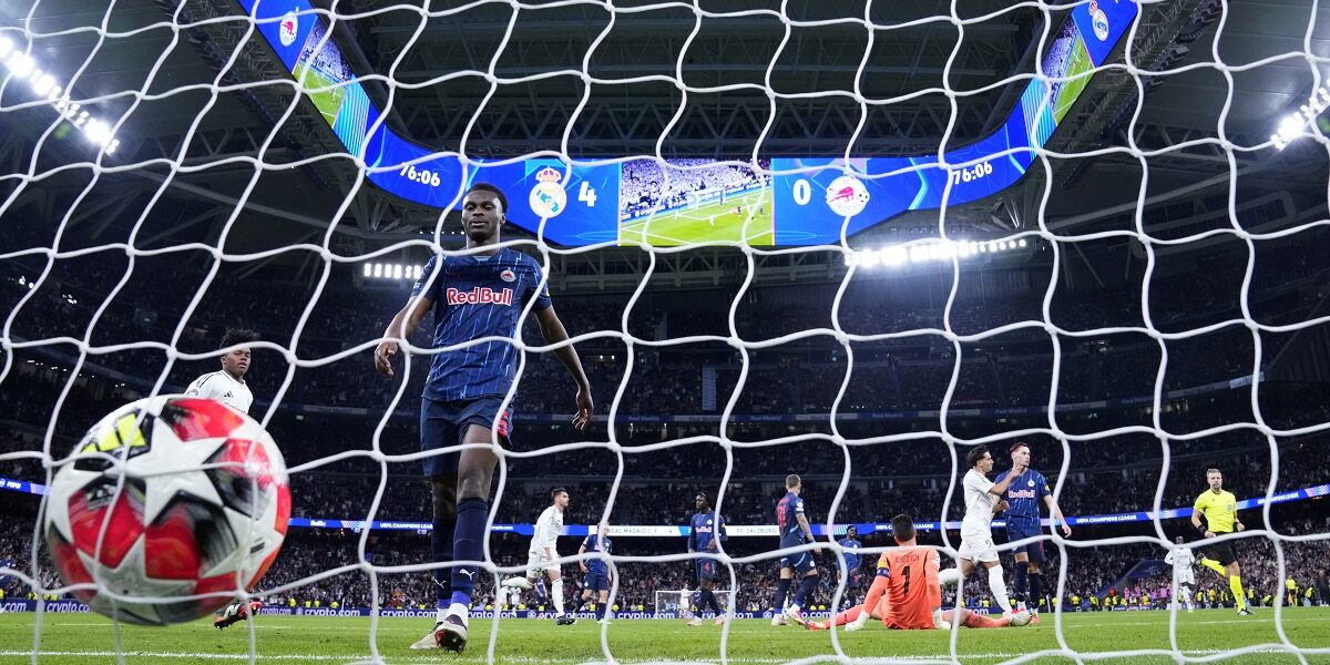 Salzburg's Samson Baidoo walks toward the ball after Real Madrid's Vinicius Junior scored his side's 5th goal during the Champions League opening phase soccer match between Real Madrid and FC Salzburg at the Santiago Bernabeu stadium in Madrid, Wednesday, Jan. 22, 2025. (AP Photo/Manu Fernandez)