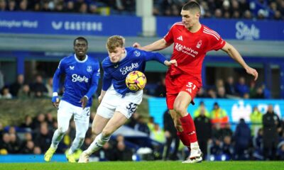 Everton's Jarrad Branthwaite, centre, and Nottingham Forest's Nikola Milenkovic battle for the ball during the English Premier League soccer match between Everton and Nottingham Forest at Goodison Park, Liverpool, England, Sunday, Dec. 29, 2024. (Peter Byrne/PA via AP)