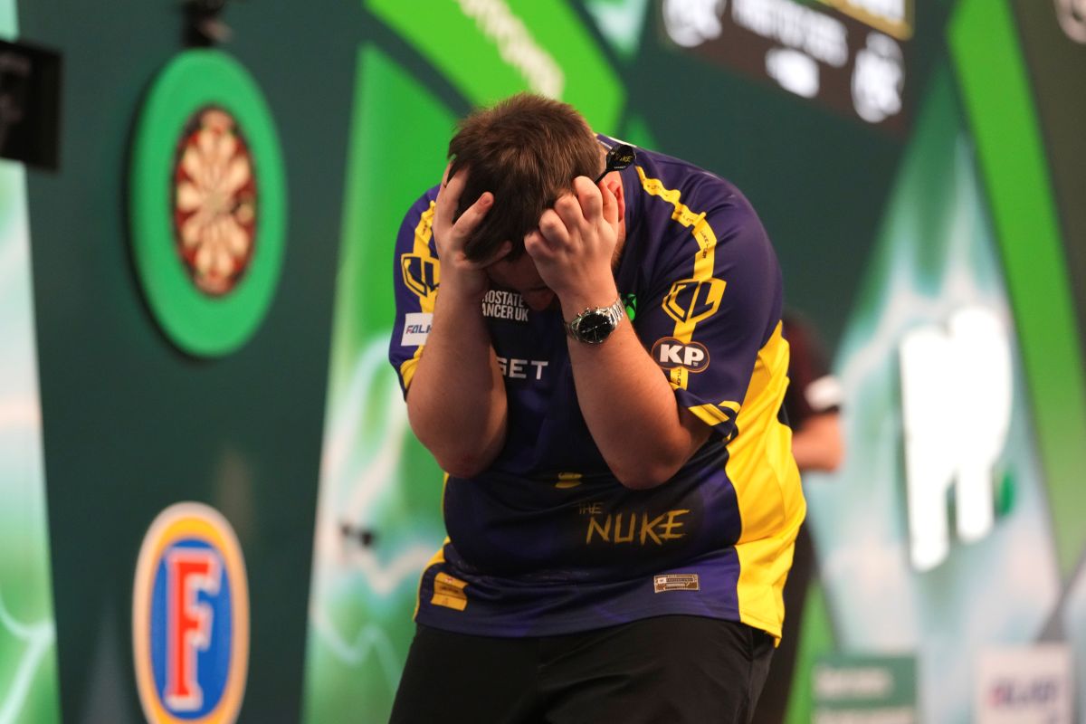 Luke Littler of England celebrates after winning the final against against Michael van Gerwen of the Netherlands at the World Darts Championship at Alexandra Palace in London, Friday, Jan. 3, 2025. (AP Photo/Kirsty Wigglesworth)