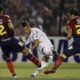 FILE - Brazil's Santos' Neymar, center, kicks the ball to score as Paraguay's Cerro Porteno's players Cesar Benitez, left, and Mariano Uglessich fail to block during a Copa Libertadores soccer game in Asuncion, Paraguay, Wednesday, June 1, 2011. (AP Photo/Cesar Olmedo, File)