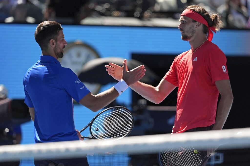 Alexander Zverev, right, of Germany shakes hands with Novak Djokovic of Serbia after Djokovic retired from their semifinal match at the Australian Open tennis championship in Melbourne, Australia, Friday, Jan. 24, 2025. (AP Photo/Ng Han Guan)