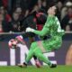 Barcelona's Alejandro Balde collides with Barcelona's goalkeeper Wojciech Szczęsny during a Champions League opening phase soccer match between SL Benfica and FC Barcelona at the Luz stadium in Lisbon, Tuesday, Jan. 21, 2025. (AP Photo/Armando Franca)