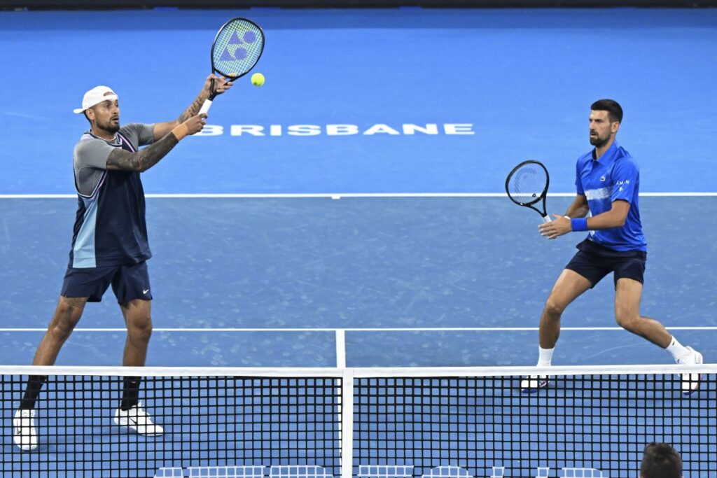 Australia's Nick Kyrgios, left, and Serbia's Novak Djokovic in action during their doubles match against Alexander Erler of Austria and Andreas Mies of Germany in the Brisbane International, at the Queensland Tennis Centre in Brisbane, Australia, Monday, Dec. 30, 2024. (Darren England/AAP Image via AP)