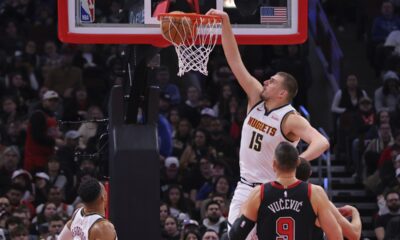 Denver Nuggets center Nikola Jokic (15) slam-dunks during the first half of an NBA basketball game against the Chicago Bulls, Monday, Jan. 27, 2025, in Chicago. (AP Photo/Melissa Tamez)