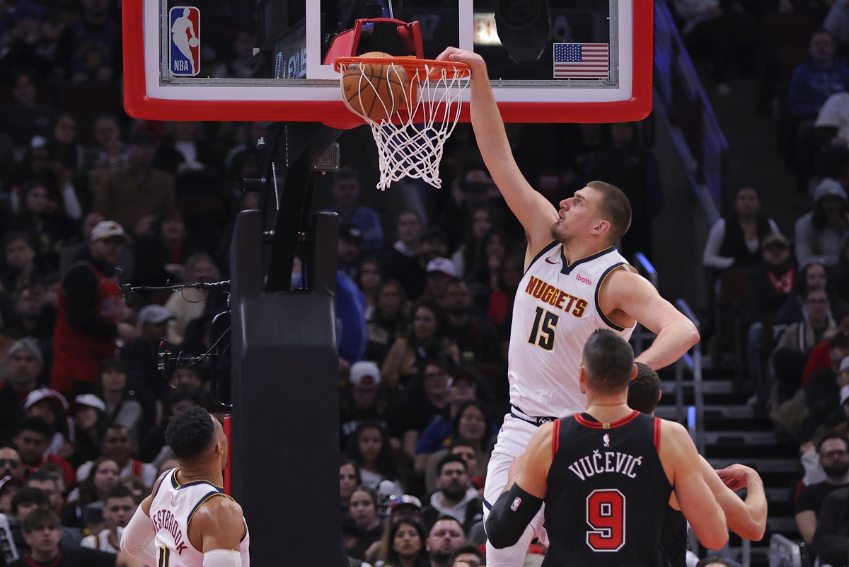 Denver Nuggets center Nikola Jokic (15) slam-dunks during the first half of an NBA basketball game against the Chicago Bulls, Monday, Jan. 27, 2025, in Chicago. (AP Photo/Melissa Tamez)