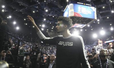 San Antonio Spurs center Victor Wembanyama (1) waves to fans as he leaves the court following a Paris Games 2025 NBA basketball game against the Indiana Pacers in Paris, Saturday, Jan. 25, 2025. (AP Photo/Thibault Camus)