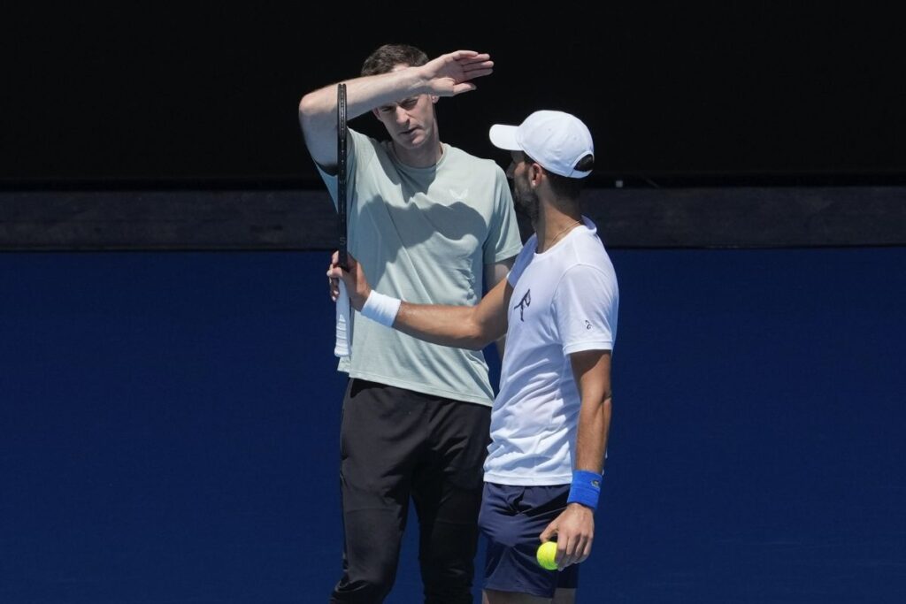 Serbia's Novak Djokovic talks with his coach Andy Murray, left, during a practice session ahead of the Australian Open tennis championship in Melbourne, Australia, Saturday, Jan. 11, 2025. (AP Photo/Manish Swarup)