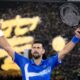 Novak Djokovic of Serbia celebrates after defeating Carlos Alcaraz of Spain in their quarterfinal match at the Australian Open tennis championship in Melbourne, Australia, Wednesday, Jan. 22, 2025. (AP Photo/Asanka Brendon Ratnayake)
