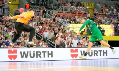 Hungary's Zoran Ilic, right, scores a goal during the quarterfinal match between Croatia and Hungary at the Handball Men's World Championships in Zagreb, Croatia, Tuesday, Jan. 28, 2025. (AP Photo/Darko Bandic)