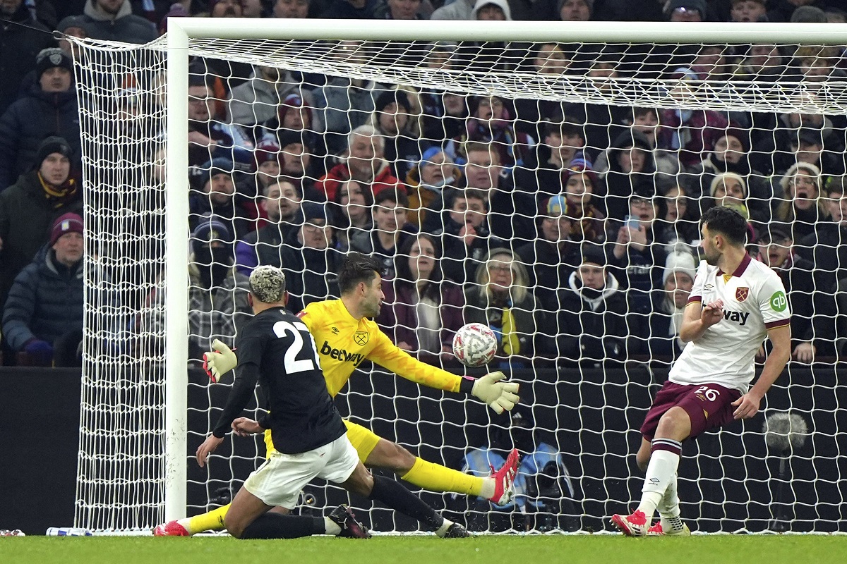 Aston Villa's Morgan Rogers, left, scores their side's second goal of the game against West Ham United during the English FA Cup third round soccer match in Birmingham, England, Friday Jan. 10, 2025. (Joe Giddens/PA via AP)