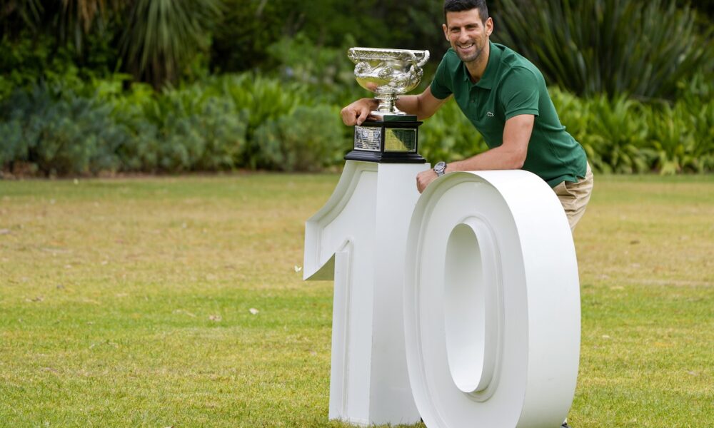 FILE - Novak Djokovic of Serbia poses with the Norman Brookes Challenge Cup in the gardens of Government House the morning after defeating Stefanos Tsitsipas of Greece in the men's singles final at the Australian Open tennis championship in Melbourne, Australia, Monday, Jan. 30, 2023. (AP Photo/Mark Baker, File)