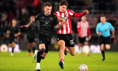 Swansea City's Josh Tymon, left and Southampton's Tyler Dibling battle for the ball, during the English FA Cup third round soccer match between Southampton and Swansea City, at St Mary's Stadium, in Southampton, England, Sunday, Jan. 12, 2025. (John Walton/PA via AP)