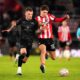 Swansea City's Josh Tymon, left and Southampton's Tyler Dibling battle for the ball, during the English FA Cup third round soccer match between Southampton and Swansea City, at St Mary's Stadium, in Southampton, England, Sunday, Jan. 12, 2025. (John Walton/PA via AP)