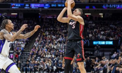 Miami Heat forward Nikola Jovic (5) attempts to shoot over Sacramento Kings forward DeMar DeRozan, left, during the first half of an NBA basketball game Monday, Jan. 6, 2025, in Sacramento, Calif. (AP Photo/Sara Nevis)