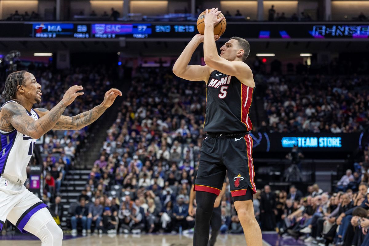 Miami Heat forward Nikola Jovic (5) attempts to shoot over Sacramento Kings forward DeMar DeRozan, left, during the first half of an NBA basketball game Monday, Jan. 6, 2025, in Sacramento, Calif. (AP Photo/Sara Nevis)