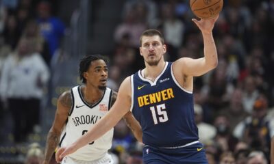 Denver Nuggets center Nikola Jokic, front, fields a pass as Brooklyn Nets center Nic Claxton defends in the first half of an NBA basketball game Friday, Jan. 10, 2025, in Denver. (AP Photo/David Zalubowski)