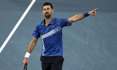 Novak Djokovic of Serbia gestures during his quarterfinal match against Carlos Alcaraz of Spain at the Australian Open tennis championship in Melbourne, Australia, Tuesday, Jan. 21, 2025. (AP Photo/Ng Han Guan)