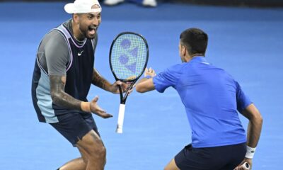 Australia's Nick Kyrgios, left, and Serbia's Novak Djokovic celebrate during their doubles match against Alexander Erler of Austria and Andreas Mies of Germany in the Brisbane International, at the Queensland Tennis Centre in Brisbane, Australia, Monday, Dec. 30, 2024. (Darren England/AAP Image via AP)