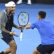 Australia's Nick Kyrgios, left, and Serbia's Novak Djokovic celebrate during their doubles match against Alexander Erler of Austria and Andreas Mies of Germany in the Brisbane International, at the Queensland Tennis Centre in Brisbane, Australia, Monday, Dec. 30, 2024. (Darren England/AAP Image via AP)